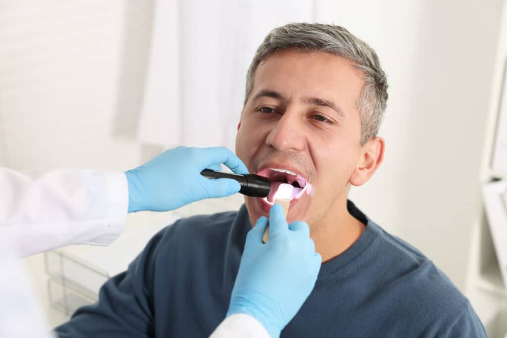 Dental patient being examined for oral cancer