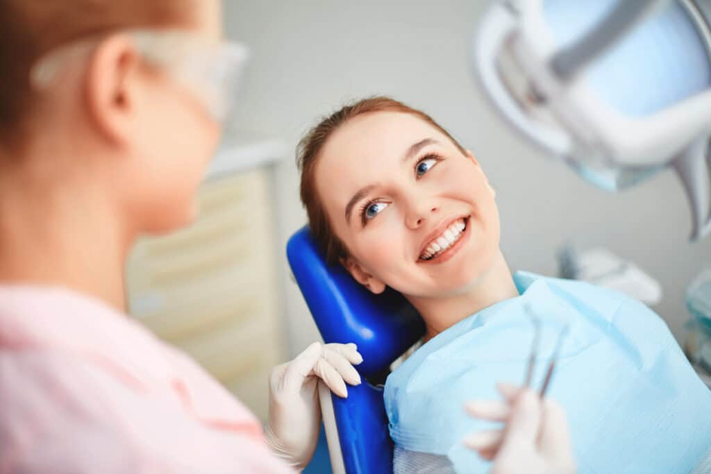 Patient sitting in the dental chair smiling