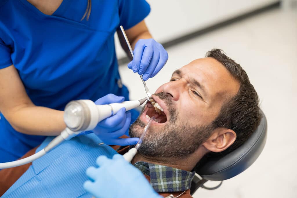 Patient having a deep dental cleaning being done