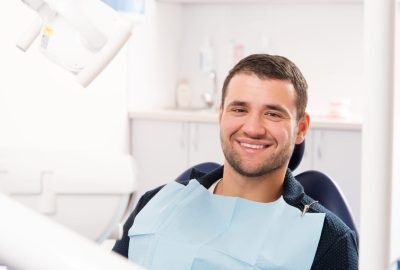 Smiling,Young,Man,At,Dentist's,Surgery